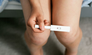 Teenage girl holding pregnancy test